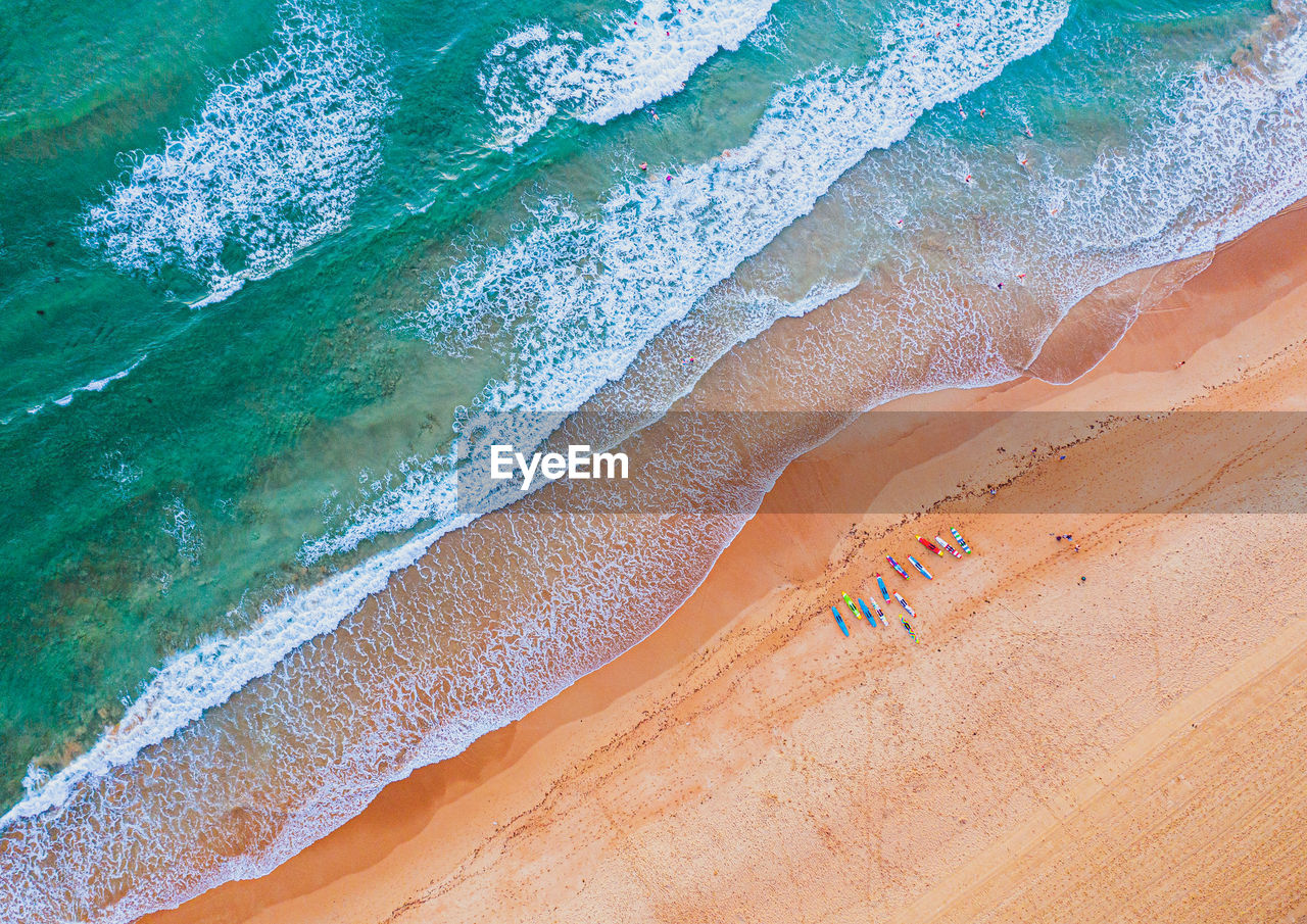 High angle view of people and waves on beach