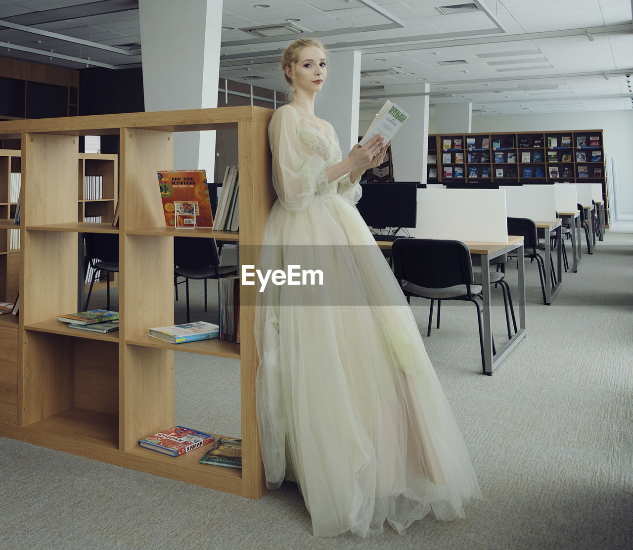A charming ballerina went to the library to choose a new book during a break 