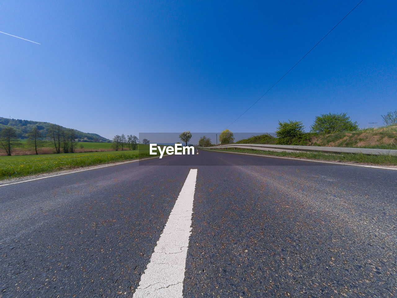 SURFACE LEVEL OF ROAD ALONG COUNTRYSIDE LANDSCAPE