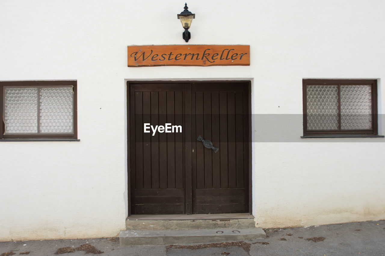 architecture, building exterior, entrance, door, built structure, closed, text, no people, building, communication, city, sign, day, home, western script, street, security, facade, wall - building feature, outdoors, wall, house, protection