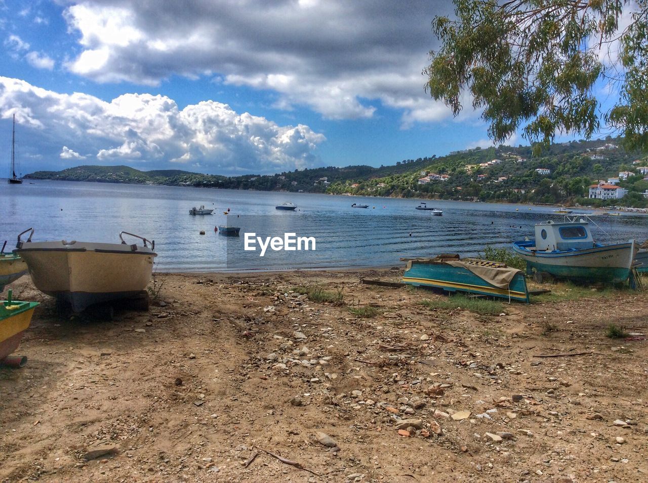 Boat moored on beach against sky