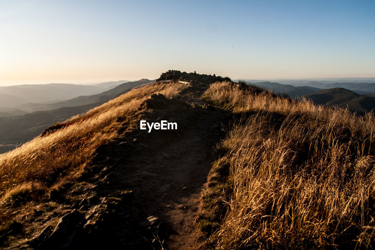 Scenic view of mountains against clear sky during sunset