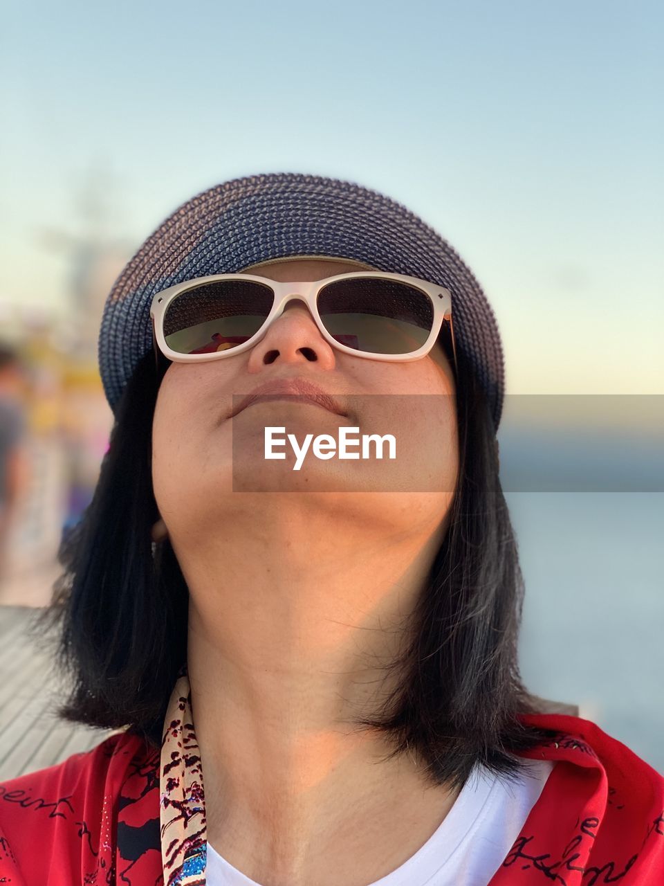 Close-up of woman wearing sunglasses looking up