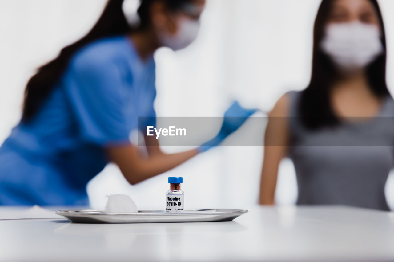 CLOSE-UP OF PEOPLE ON TABLE IN KITCHEN