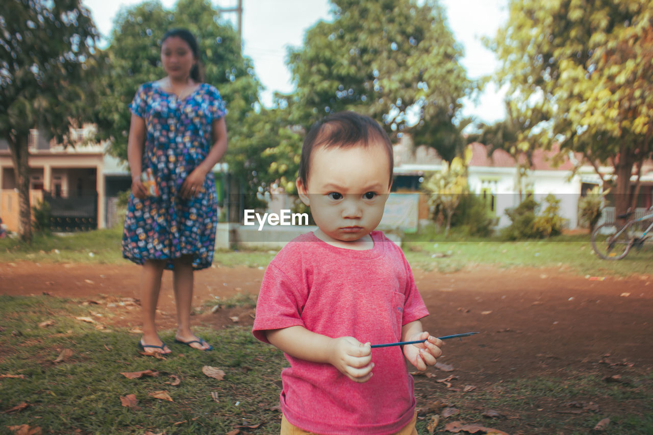 Portrait of boy standing on land