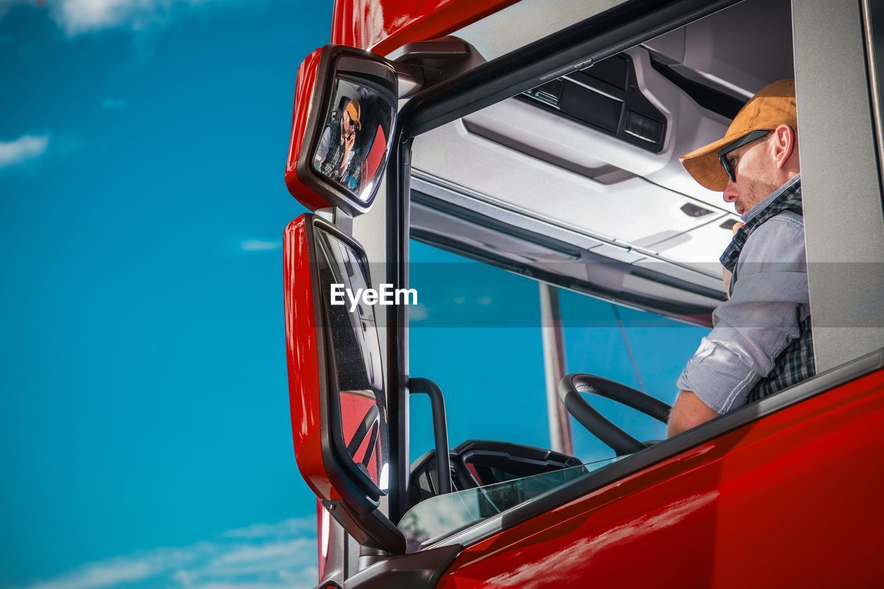 Low angle view of man driving truck