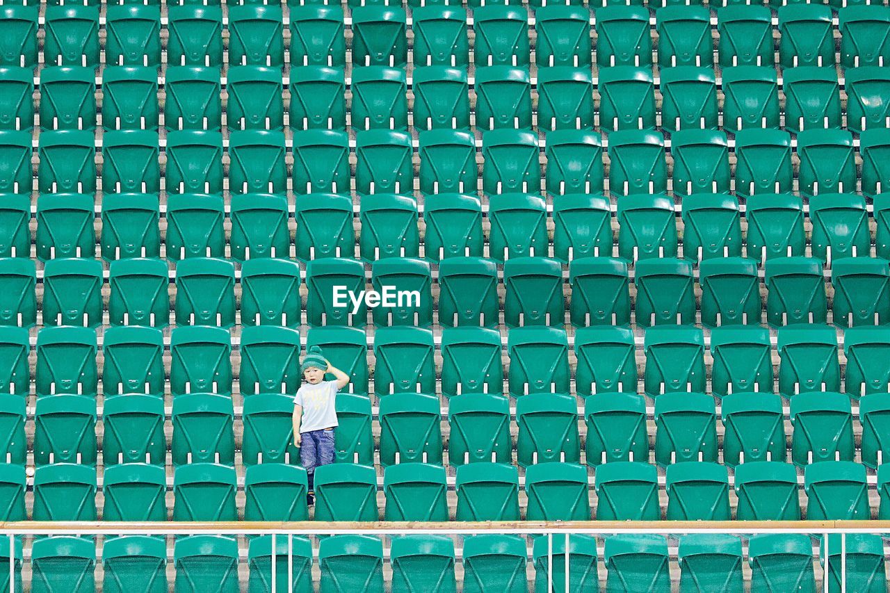 Portrait of a boy against green stairs