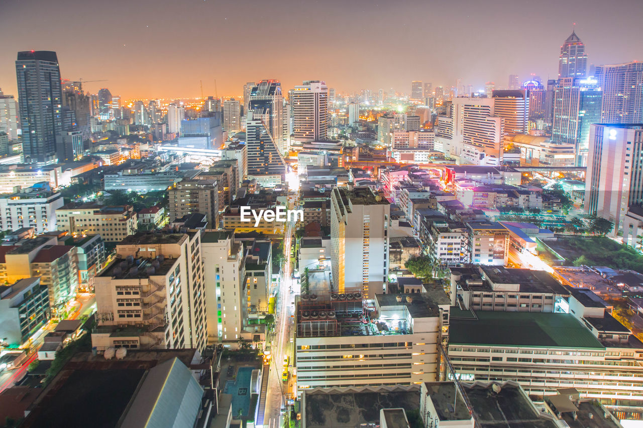 High angle view of city lit up at night