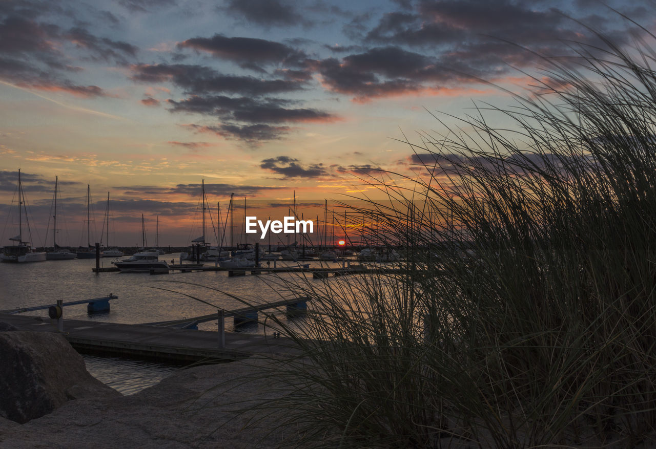 Scenic view of beach against cloudy sky