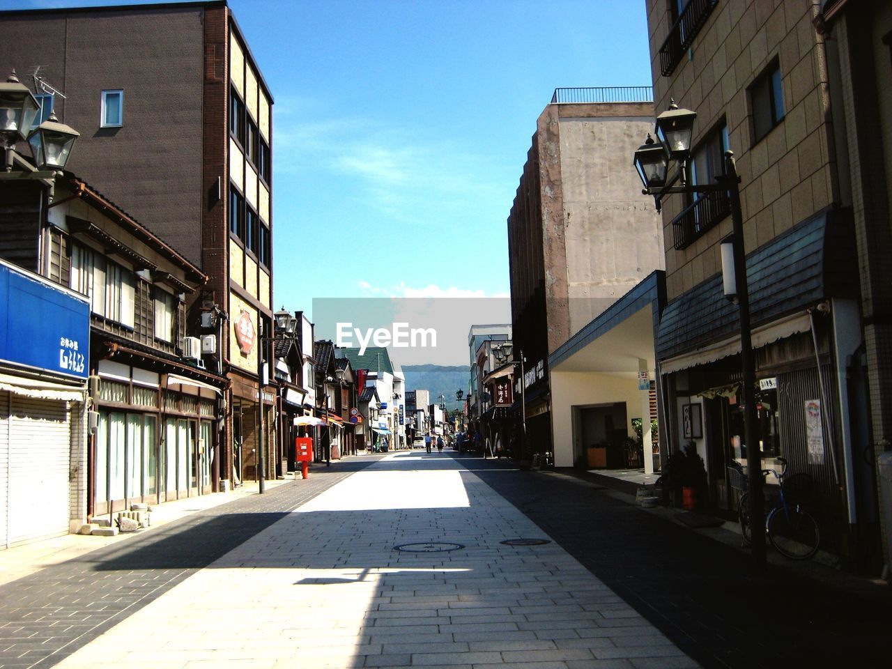 Street amidst buildings against sky