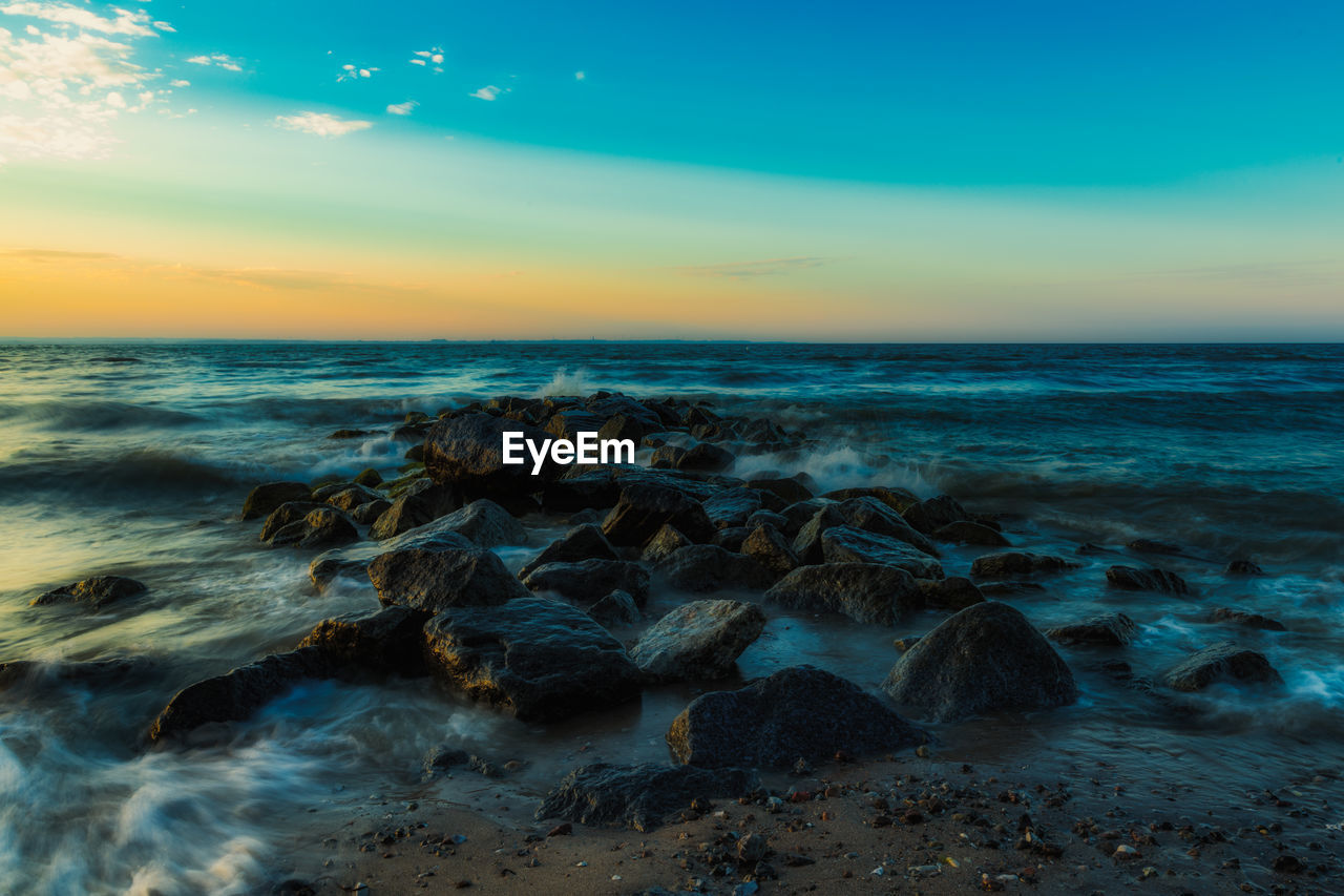 scenic view of sea at sunset