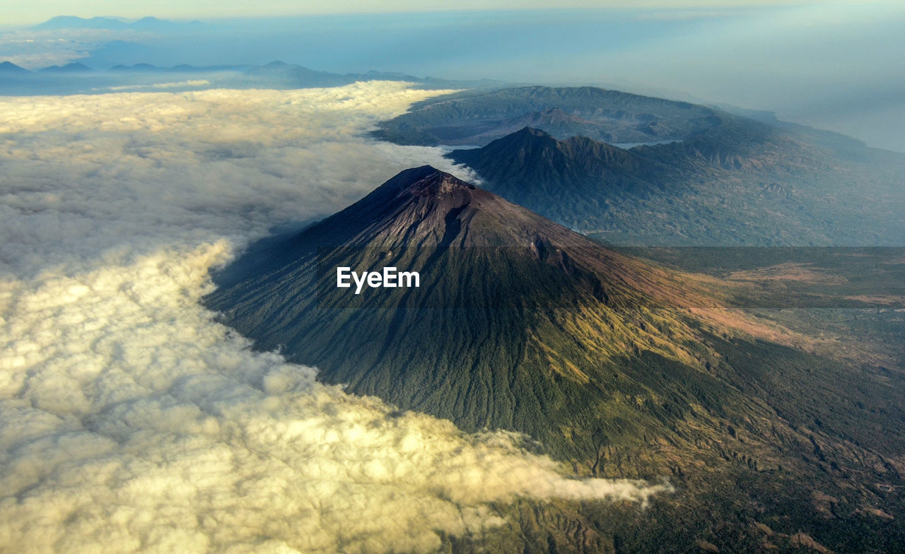Mount agung covered with cloud with mount batur in the background.