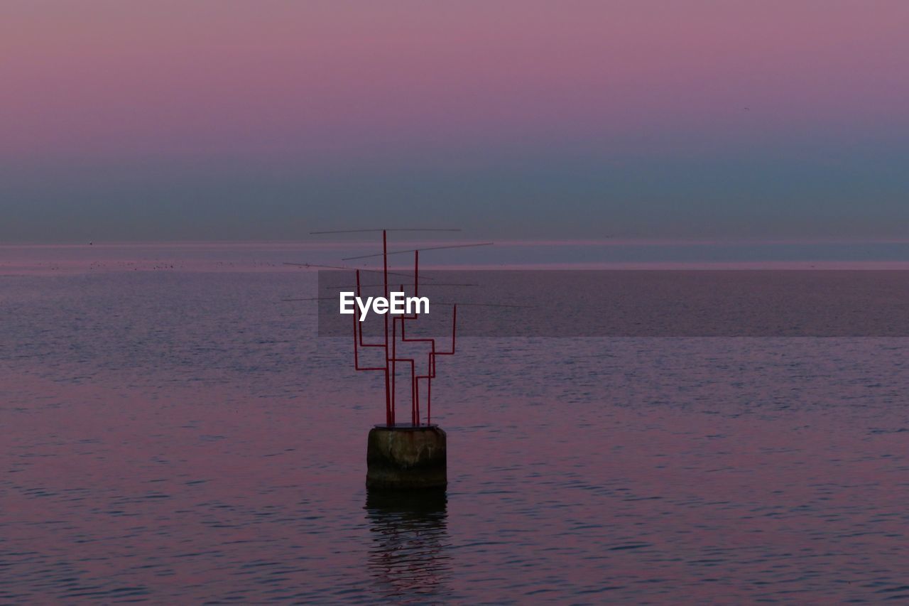 Scenic view of sea against sky at sunset