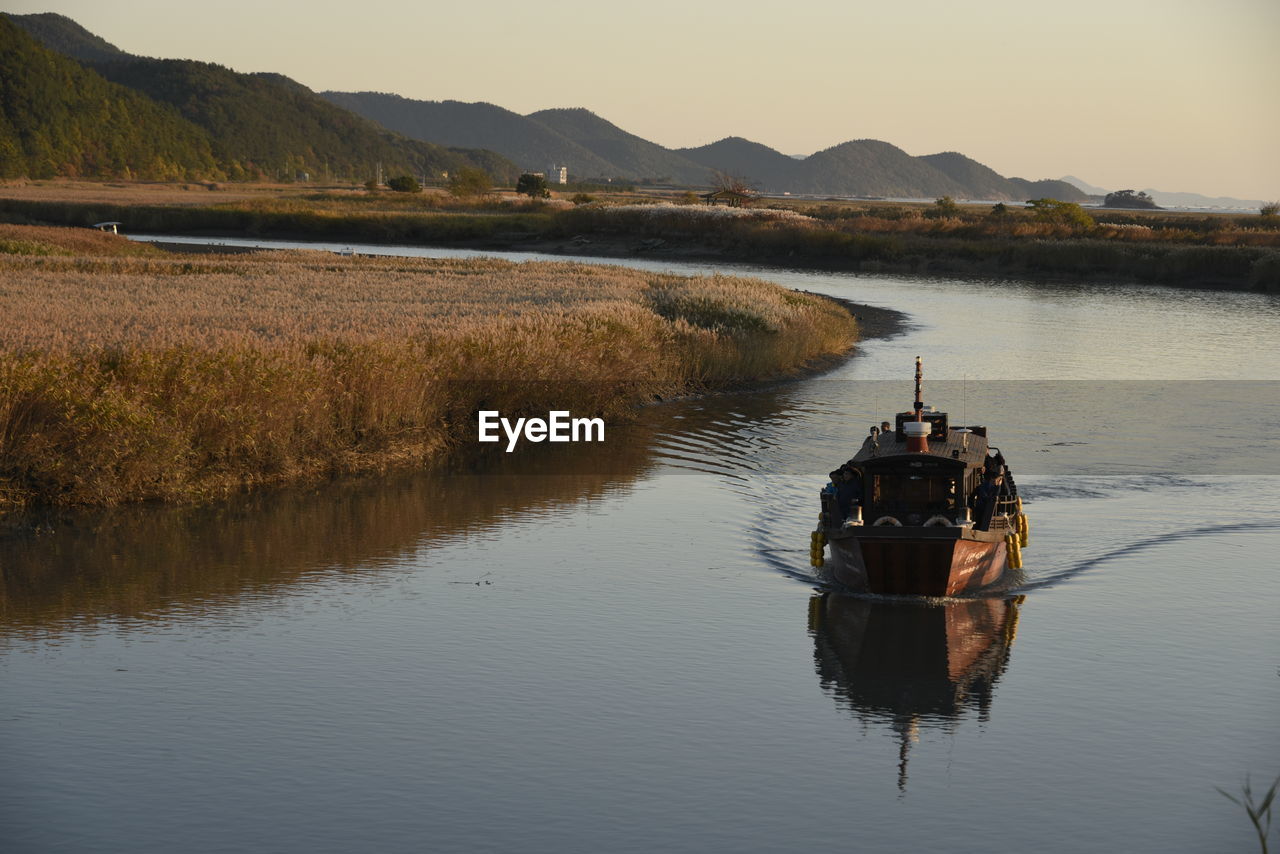 Boat on lake against sky