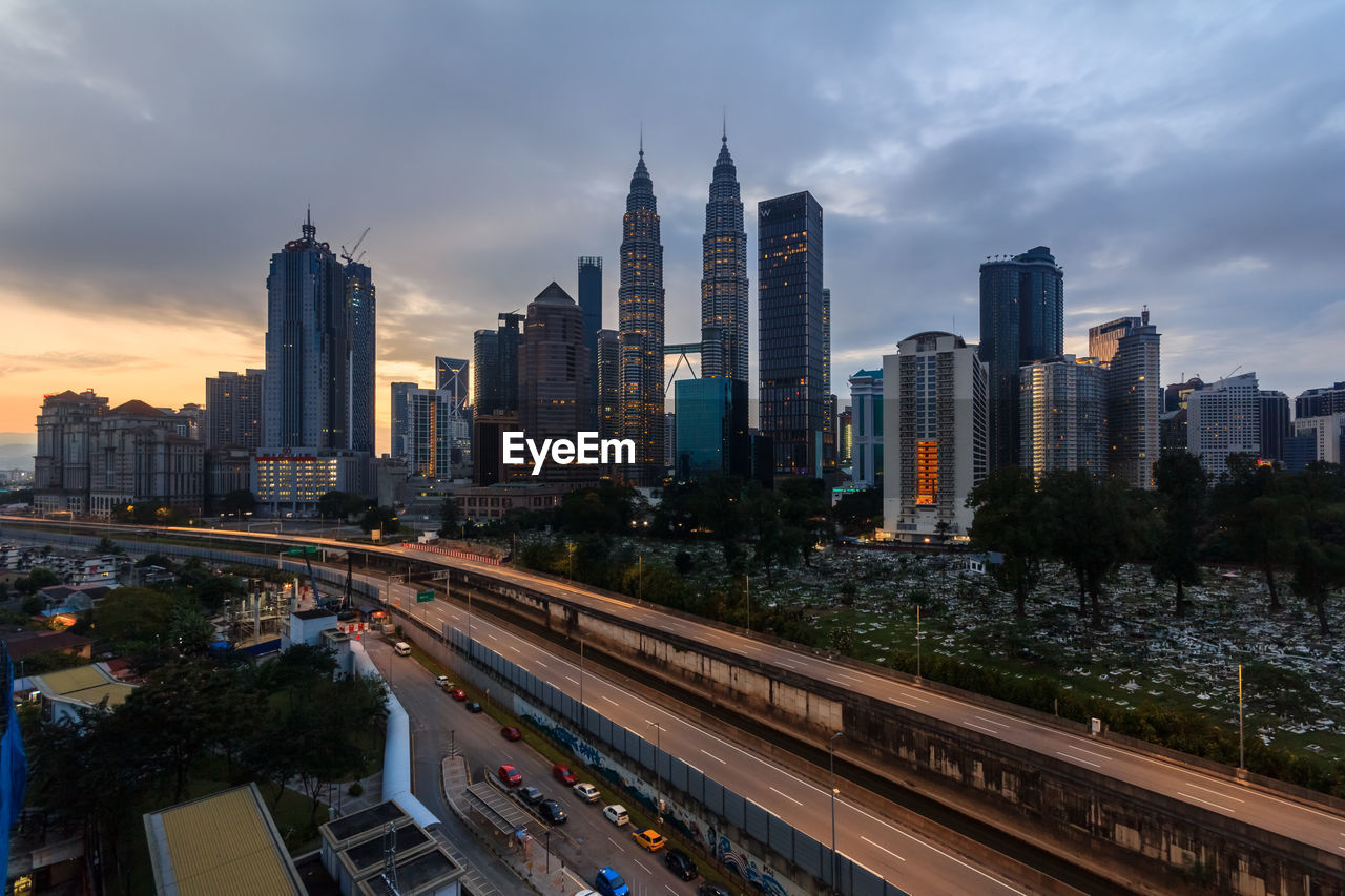 VIEW OF MODERN BUILDINGS AGAINST SKY DURING SUNSET