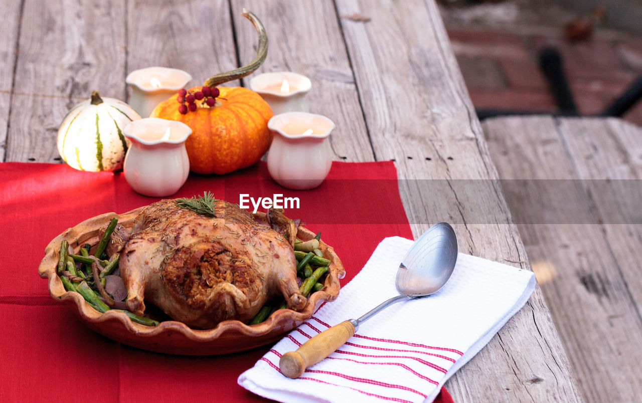 High angle view of roast chicken in container on table