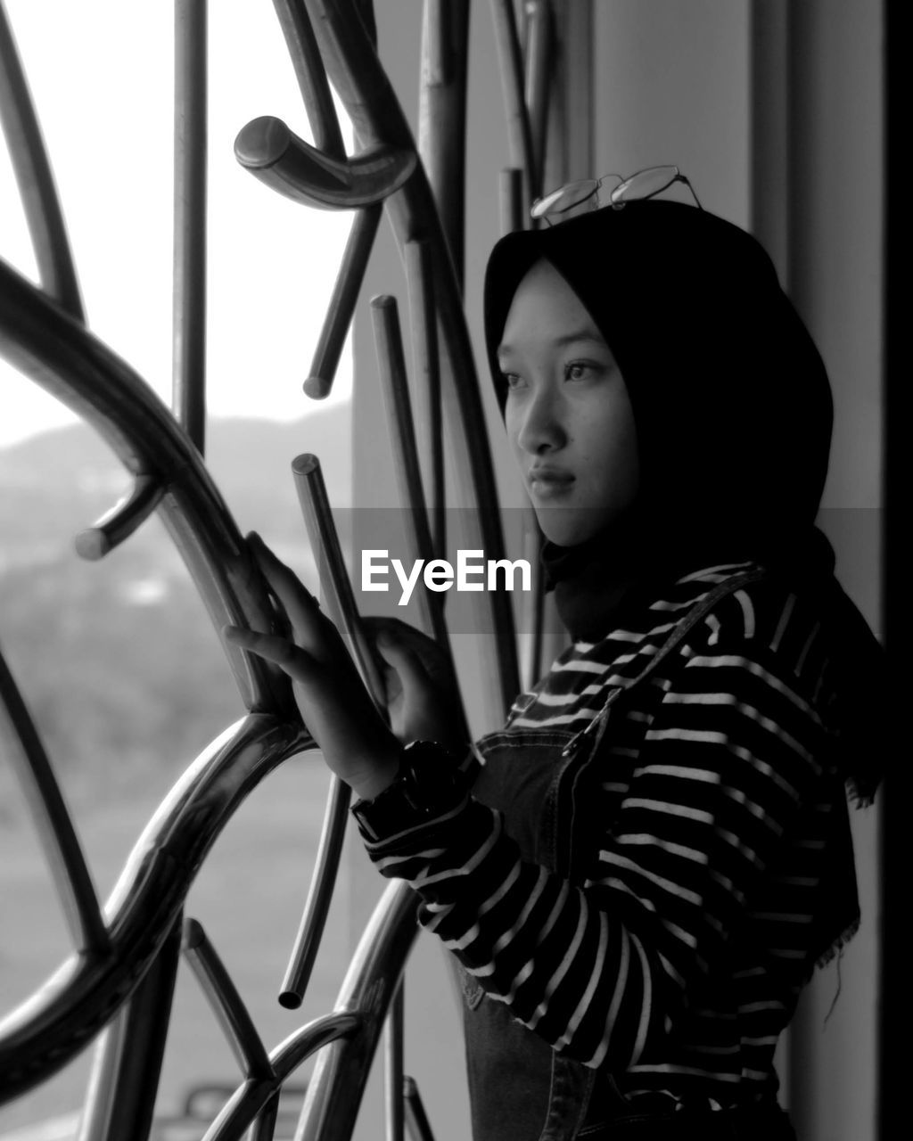 Teenage girl looking through window