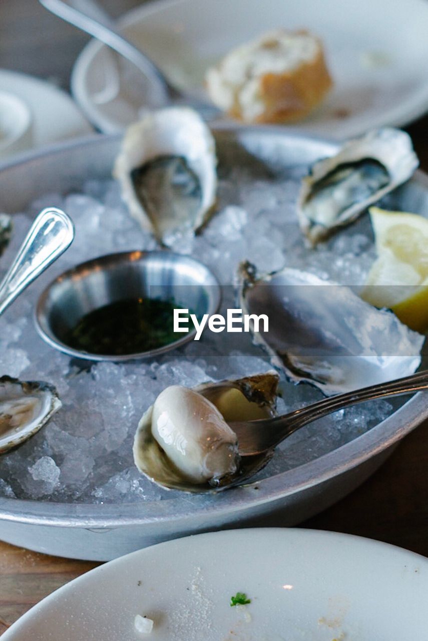 Close-up of oysters on ice in bowl