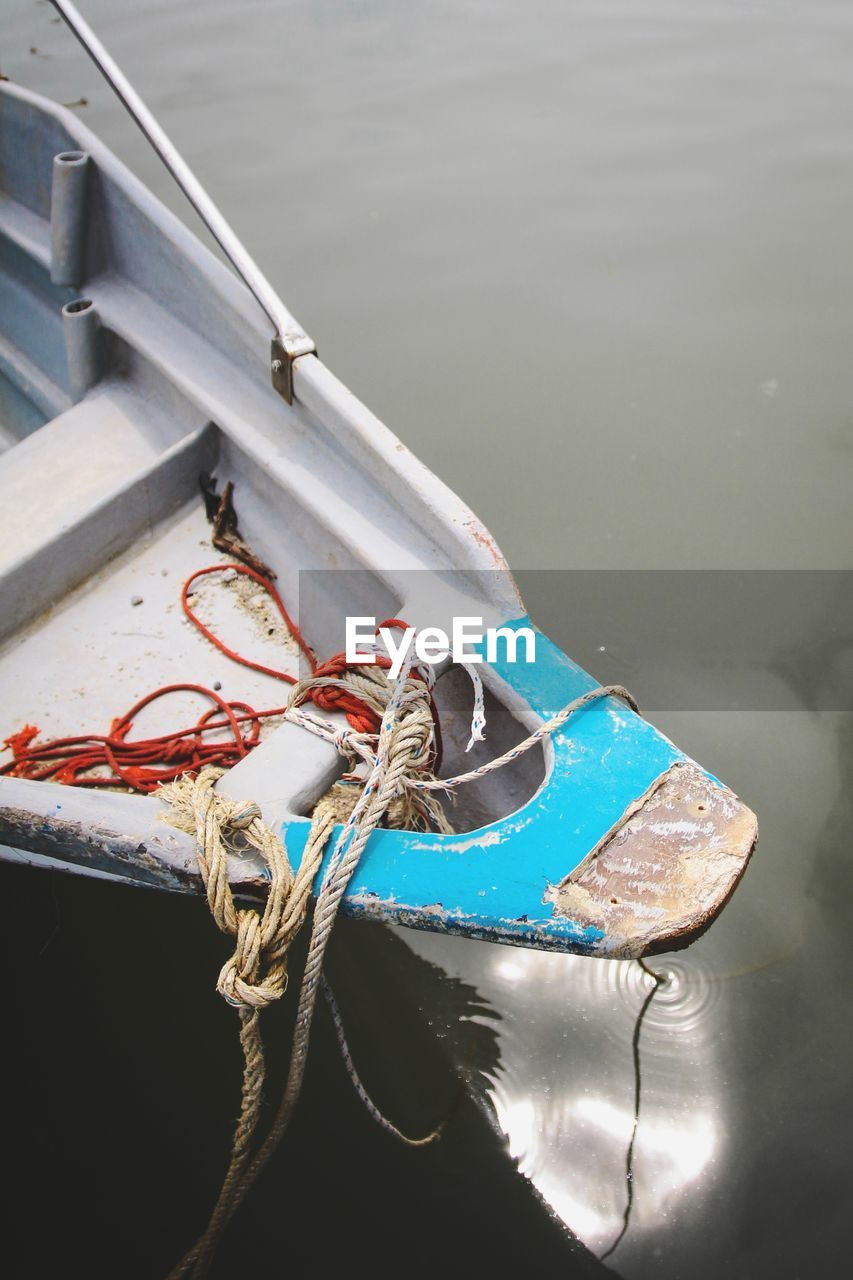 High angle view of rope tied on boat moored in lake