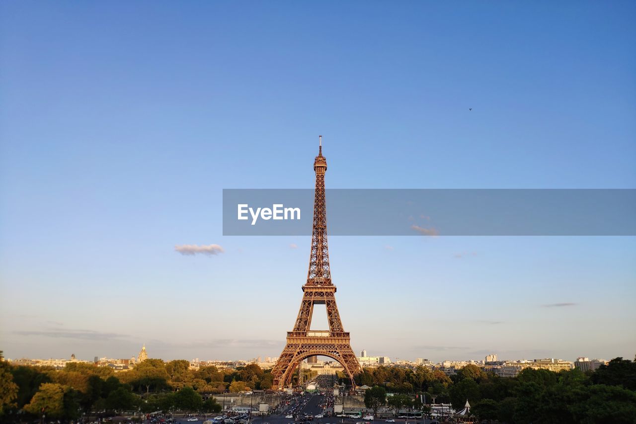 Eiffel tower in city against sky