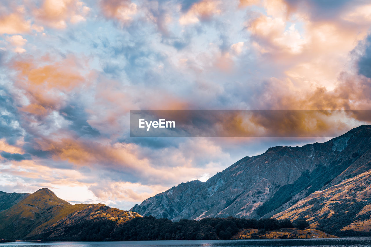 Scenic view of snowcapped mountains against sky during sunset