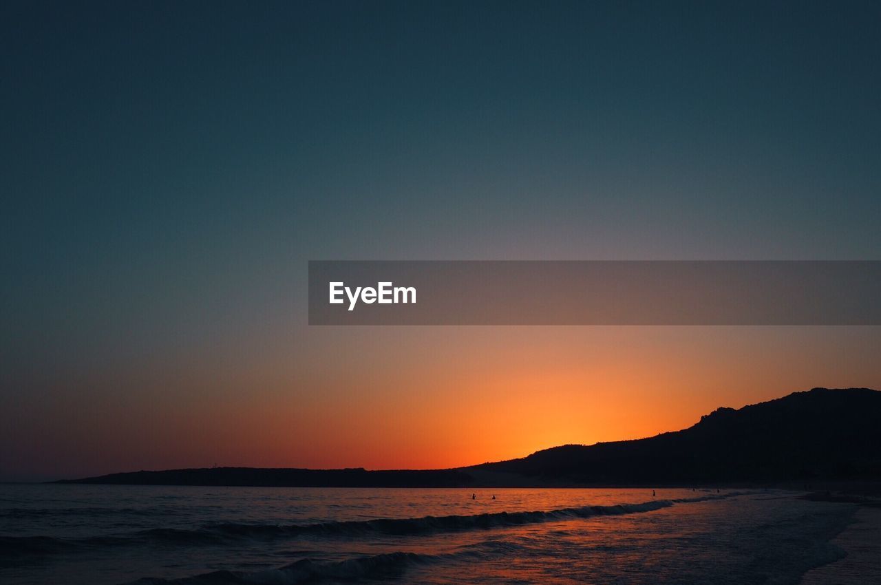 Scenic view of sea against sky at sunset