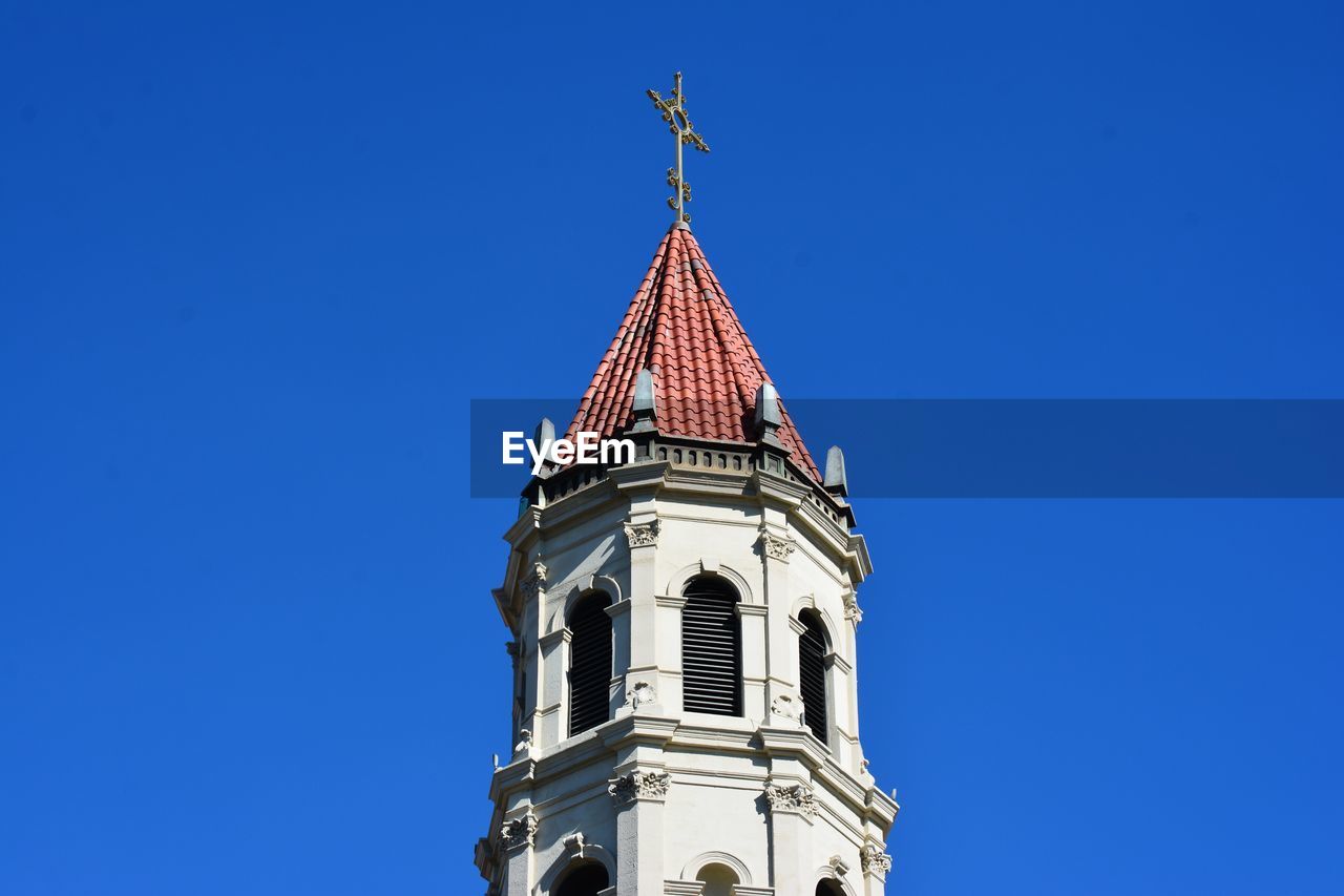 Low angle view of building against clear blue sky