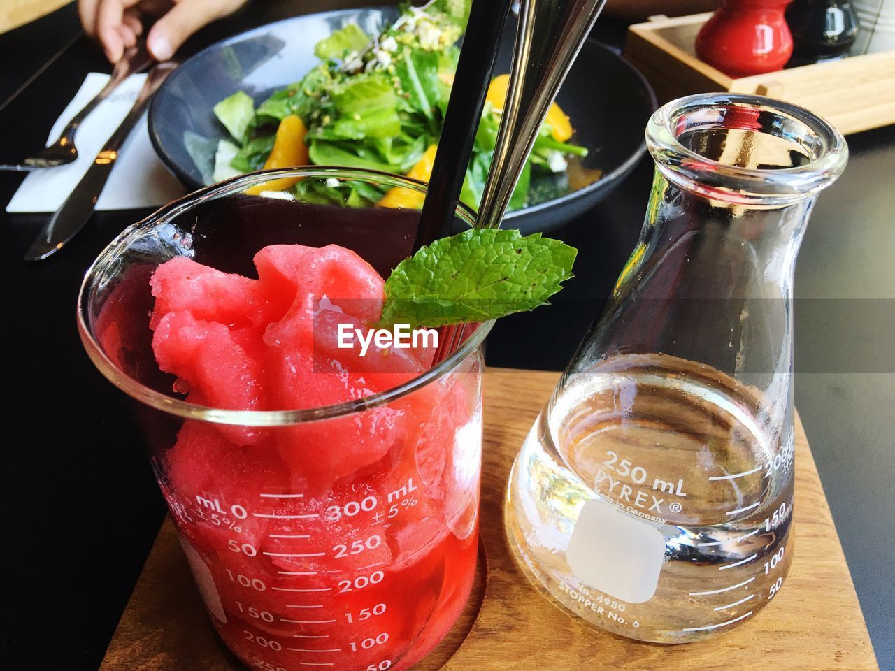 High angle view of drink in beaker with conical flask on table at restaurant