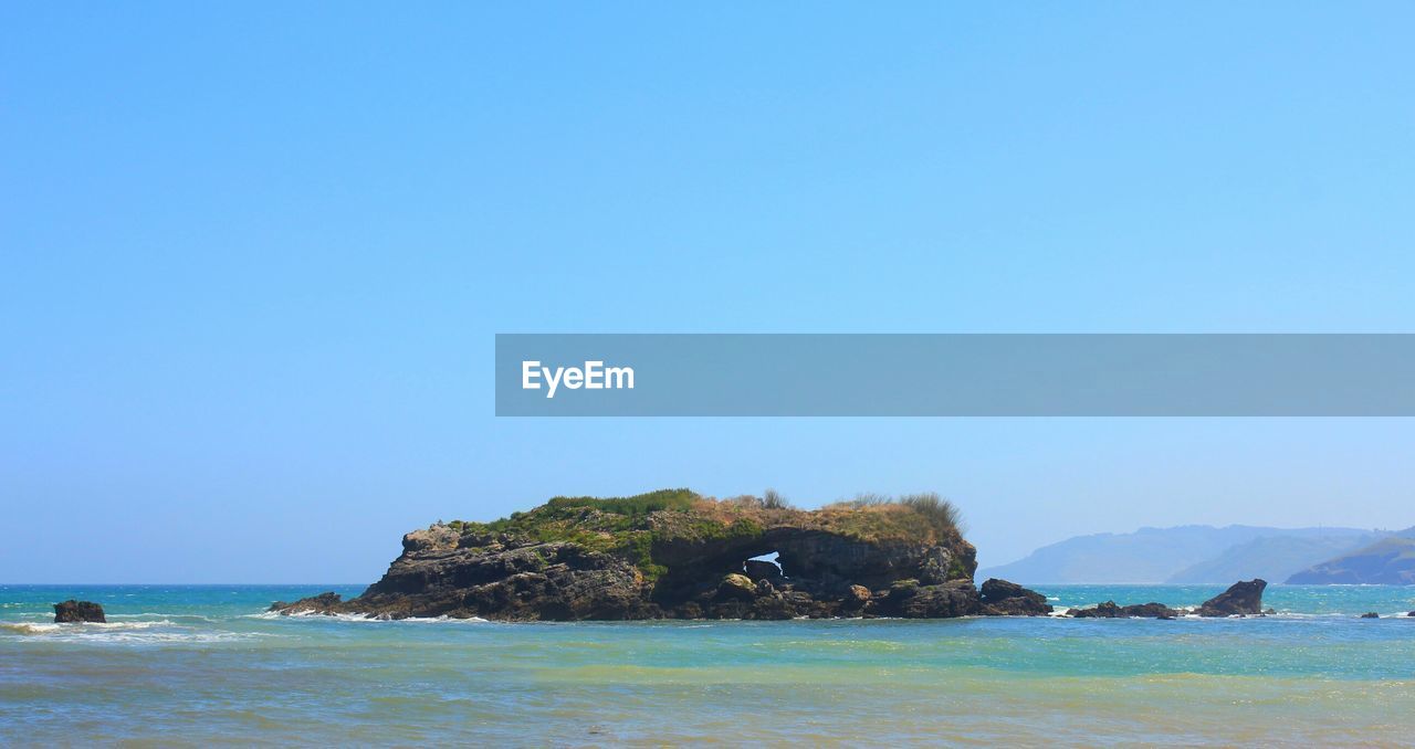 Scenic shot of headland in calm blue sea