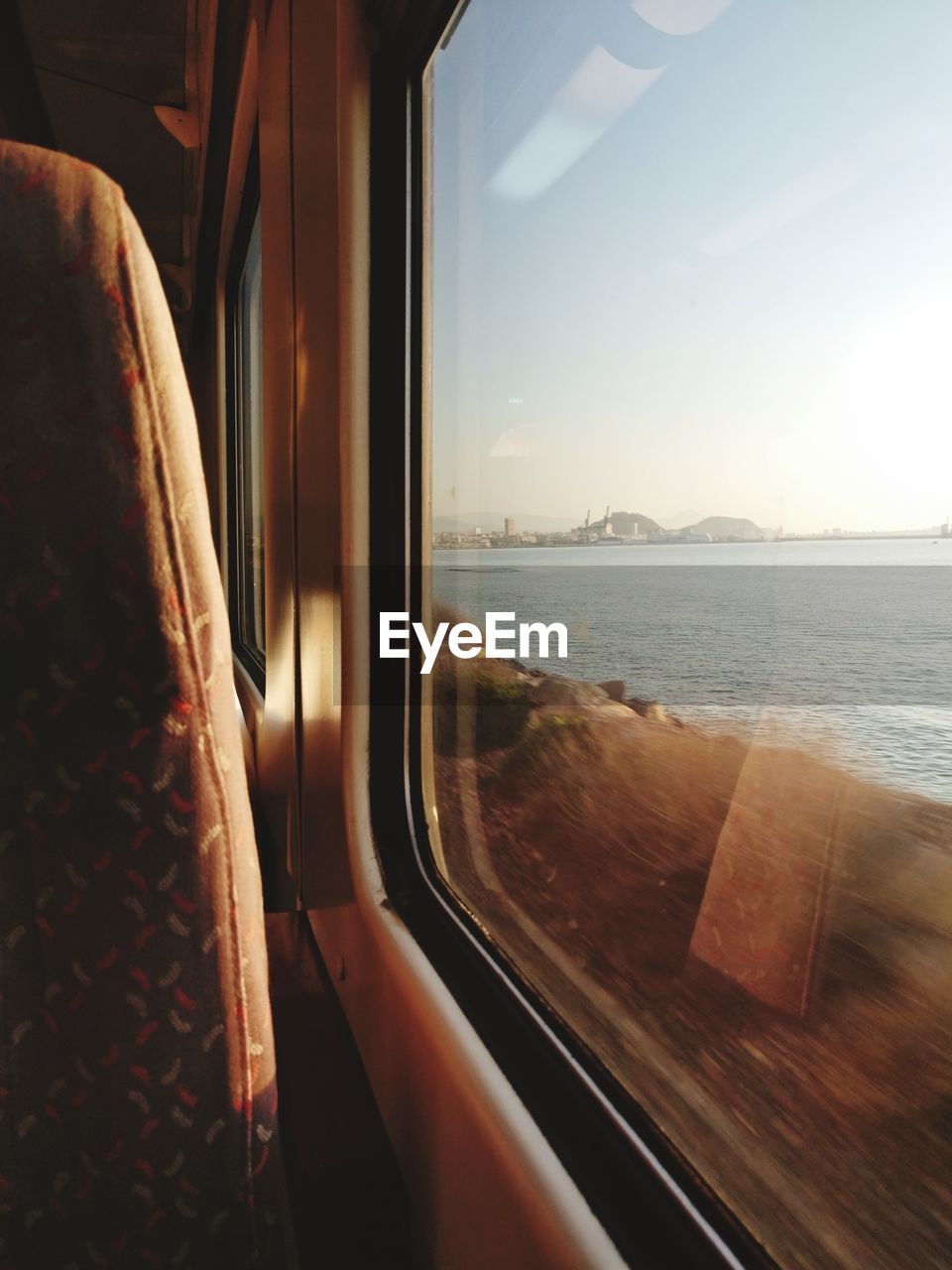 Scenic view of sea seen through train window