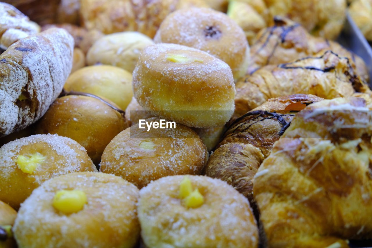 Italian pastries, croissants and zeppole, deep-fried dough ball, topped with powdered sugar