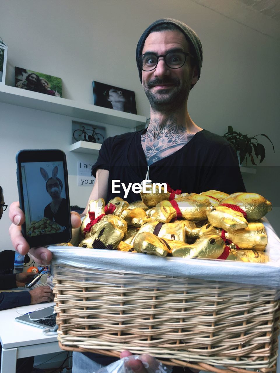 Portrait of man holding basket with chocolates