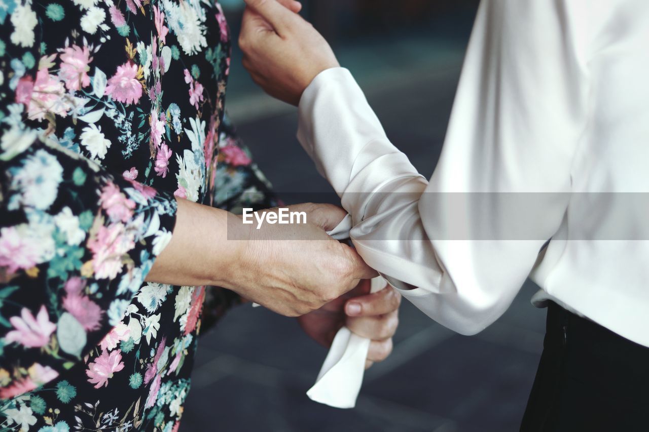 Close-up of woman getting dressed