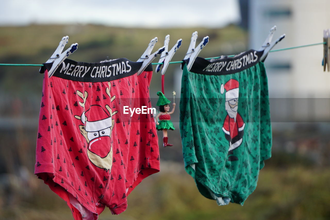 hanging, clothesline, clothing, spring, red, drying, focus on foreground, laundry, textile, no people, day, clothespin, outdoors, nature, multi colored