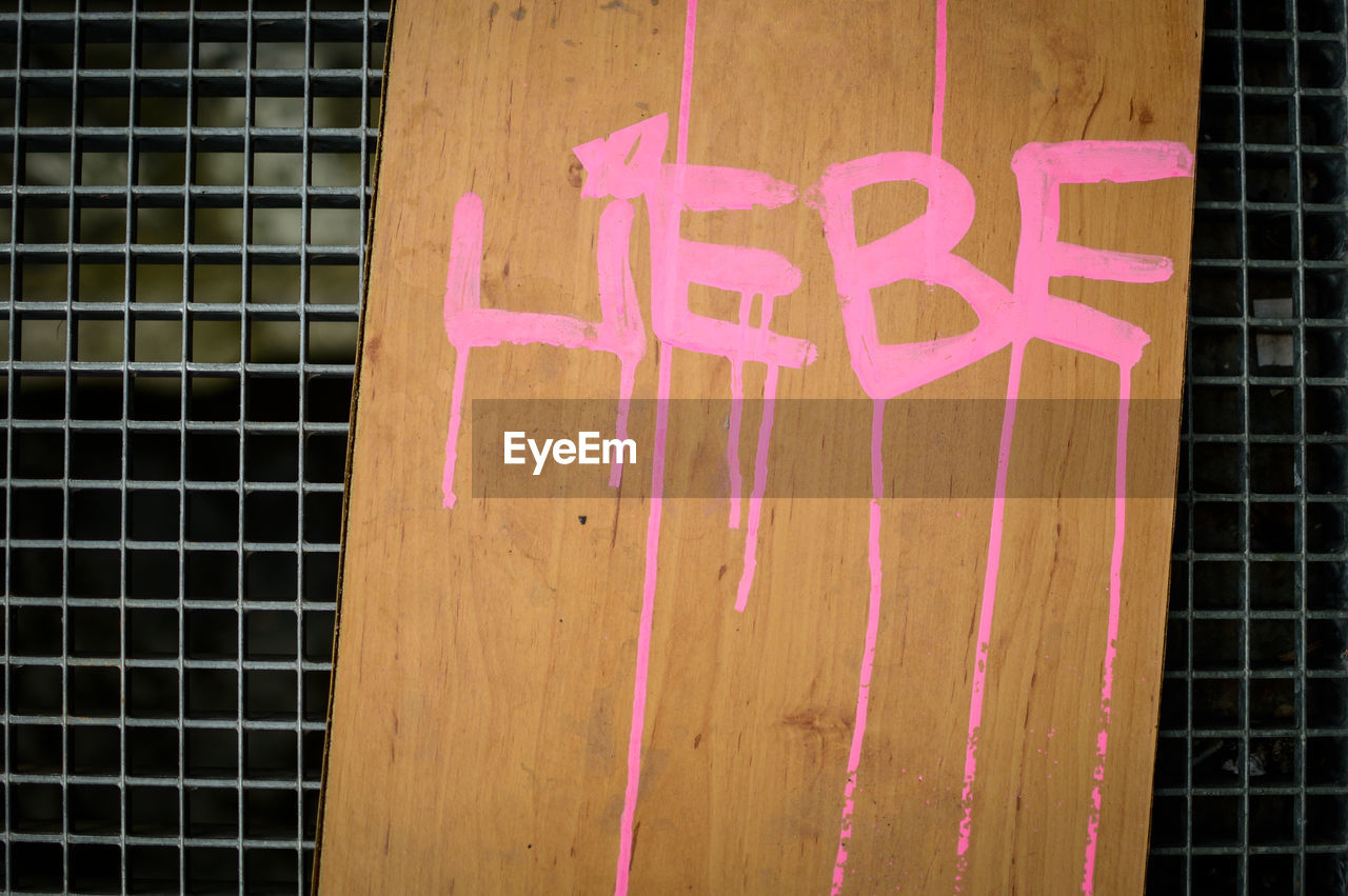 CLOSE-UP OF TEXT ON PINK PETALS