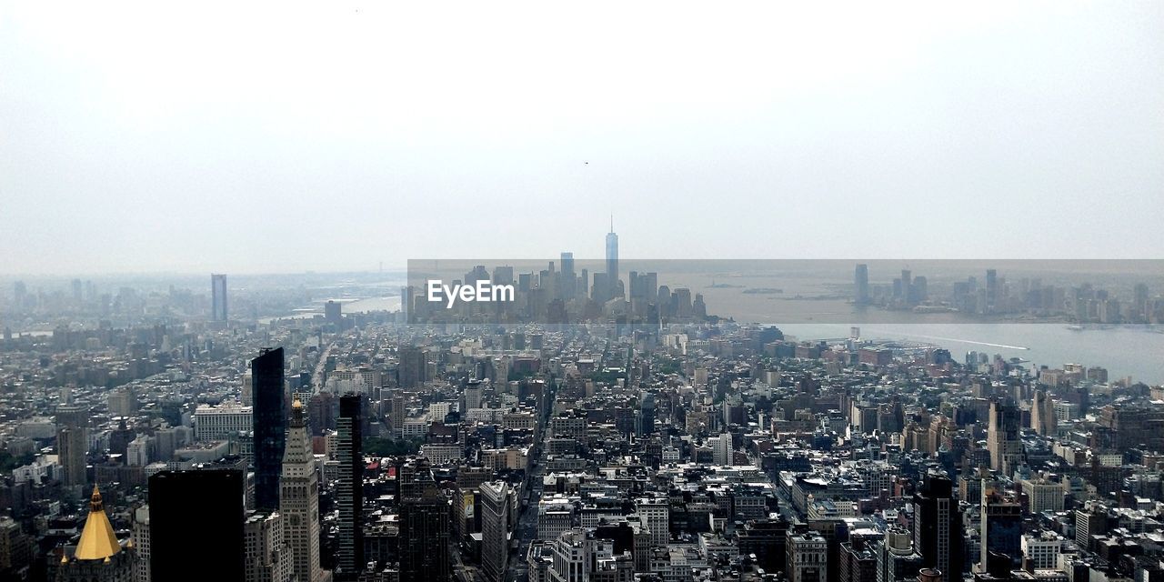 Aerial view of modern buildings in city against sky