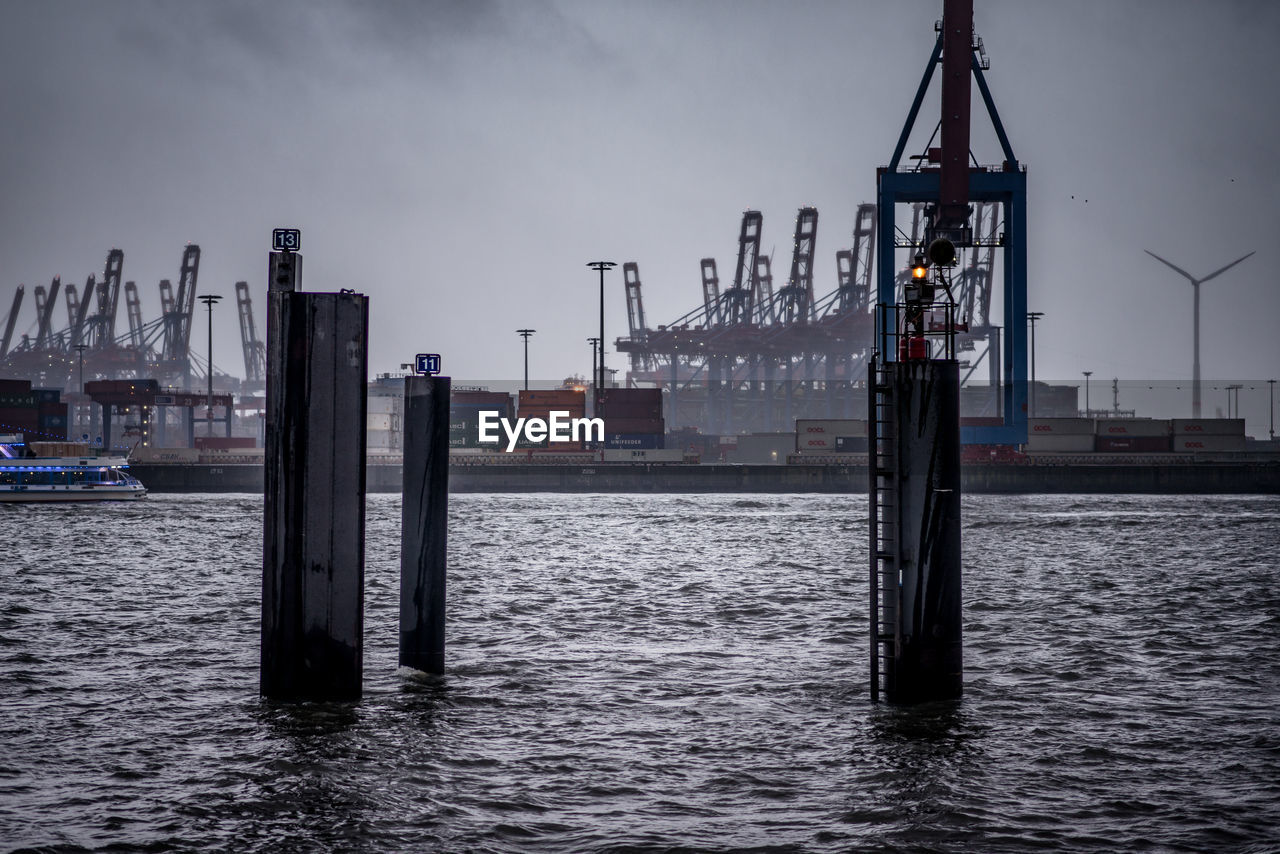 Container ship moored at harbor in city