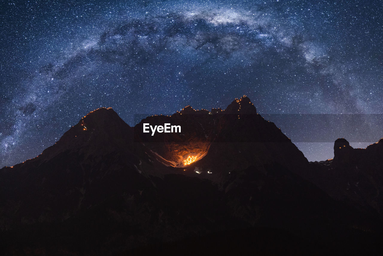 Scenic view of mountain against sky at night