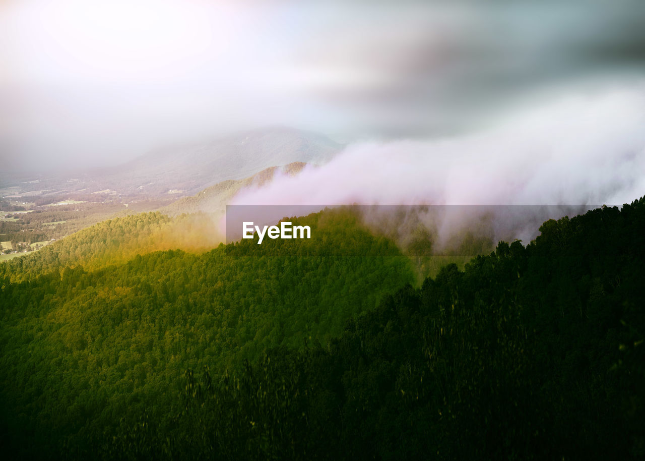 Scenic view of mountain against sky in foggy weather