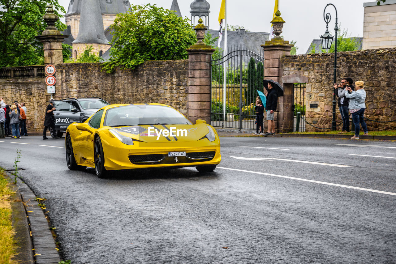 VIEW OF YELLOW CAR ON STREET