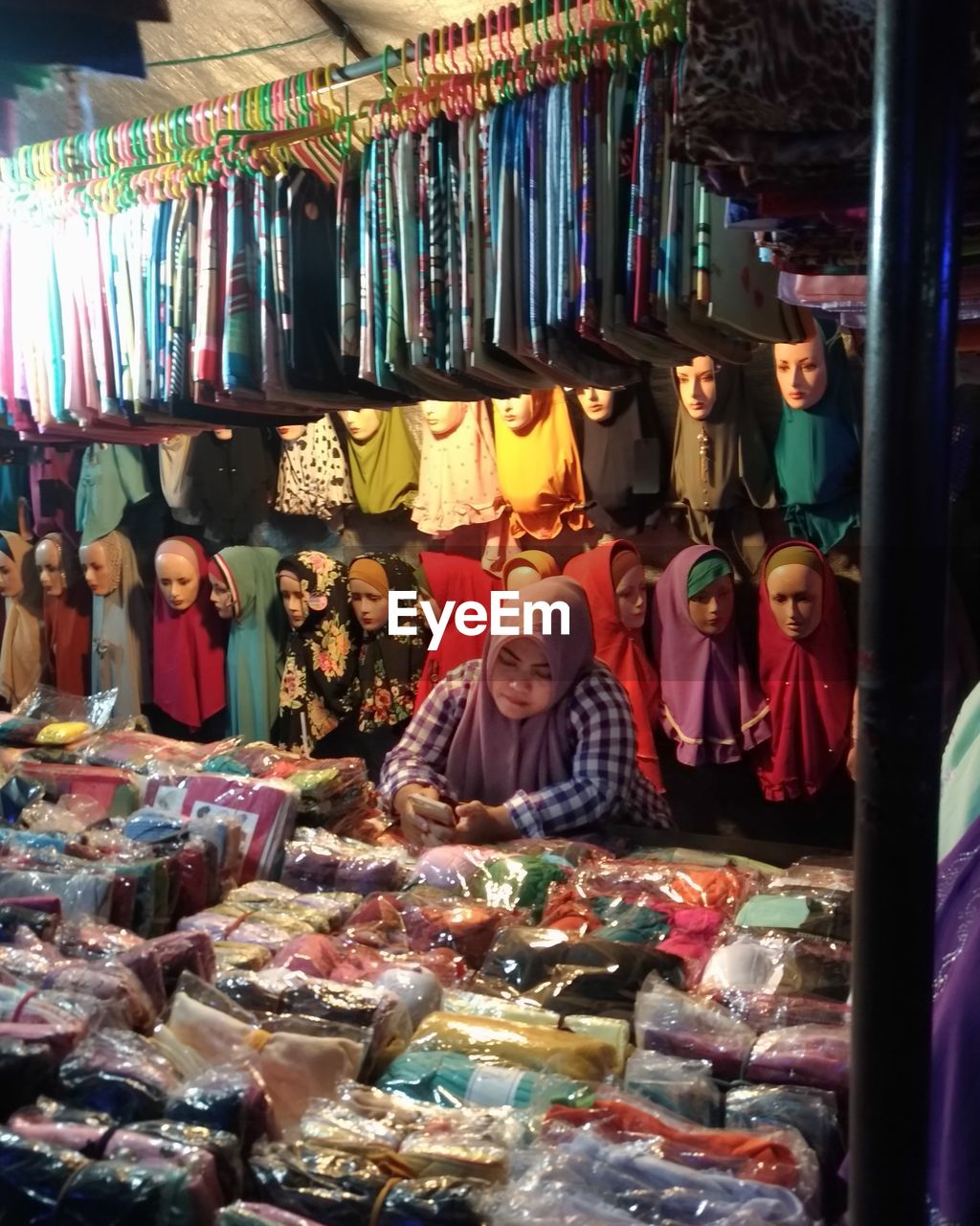 PEOPLE IN MARKET STALL