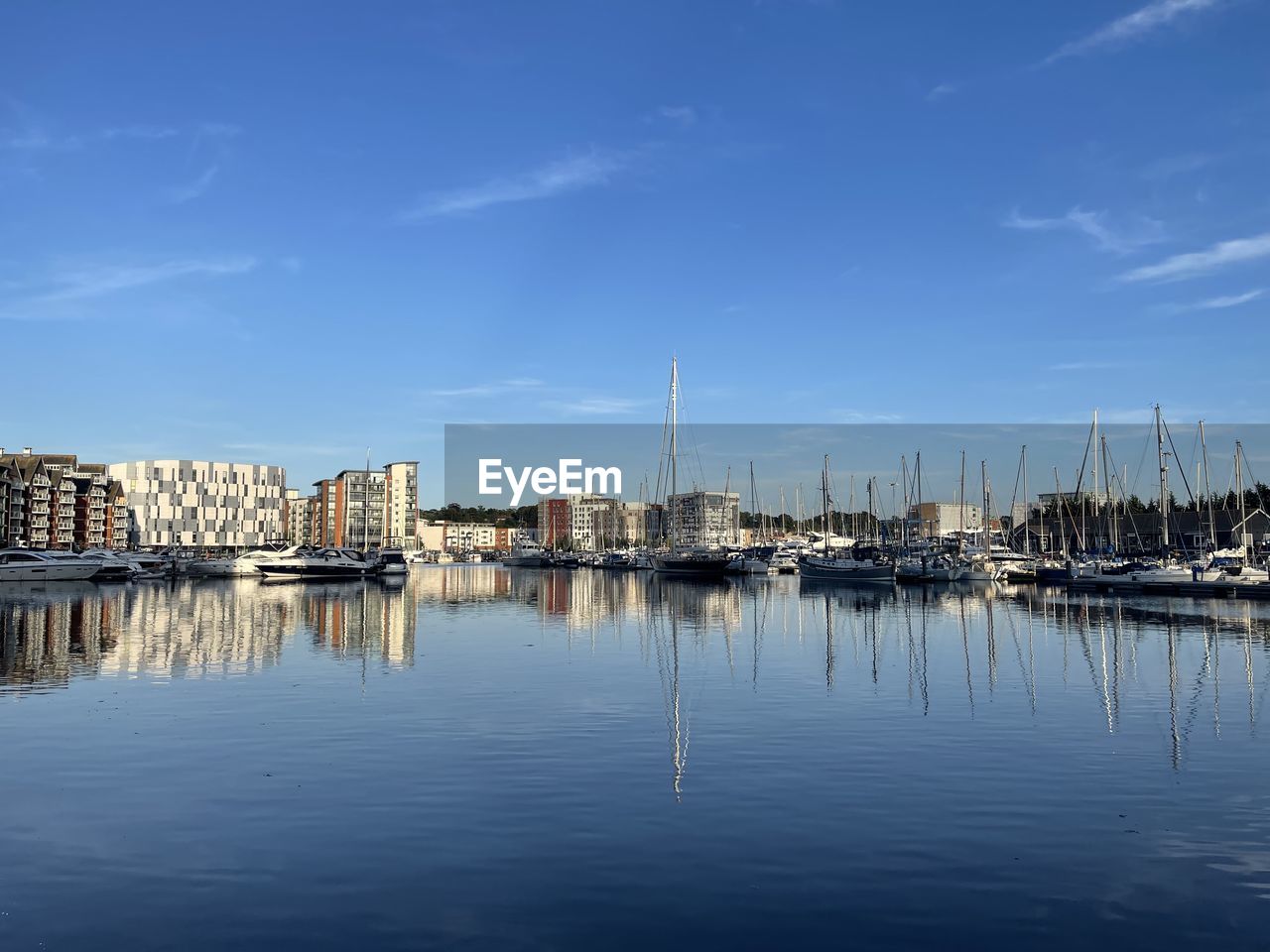 water, reflection, marina, sky, dock, harbor, architecture, nautical vessel, transportation, built structure, sea, cityscape, building exterior, nature, no people, horizon, dusk, mode of transportation, sailboat, city, ship, blue, building, waterfront, skyline, cloud, vehicle, travel destinations, day, boat, moored, outdoors, evening, bay, travel, port, mast, pier, tranquility, beauty in nature