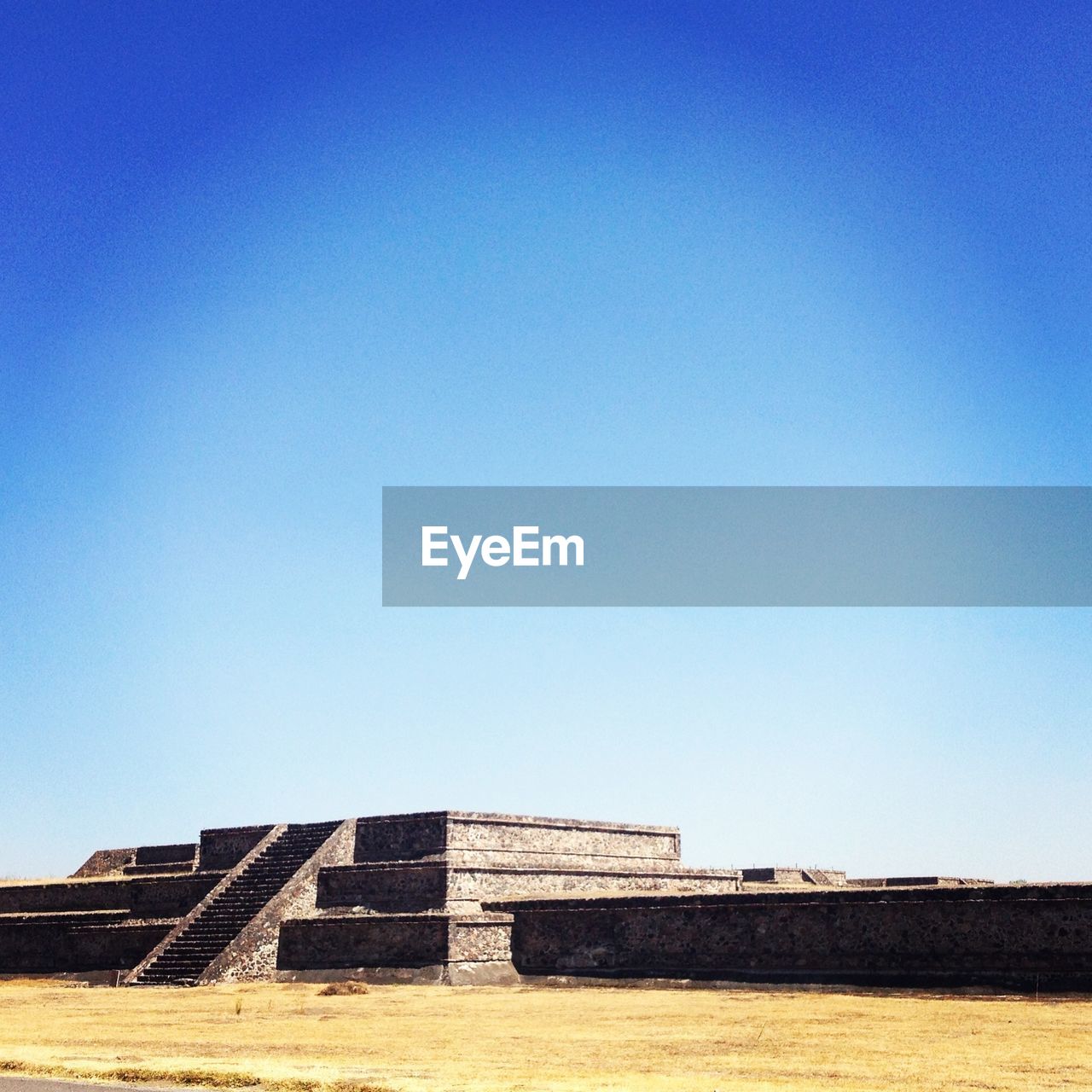 LOW ANGLE VIEW OF BUILT STRUCTURES AGAINST CLEAR BLUE SKY