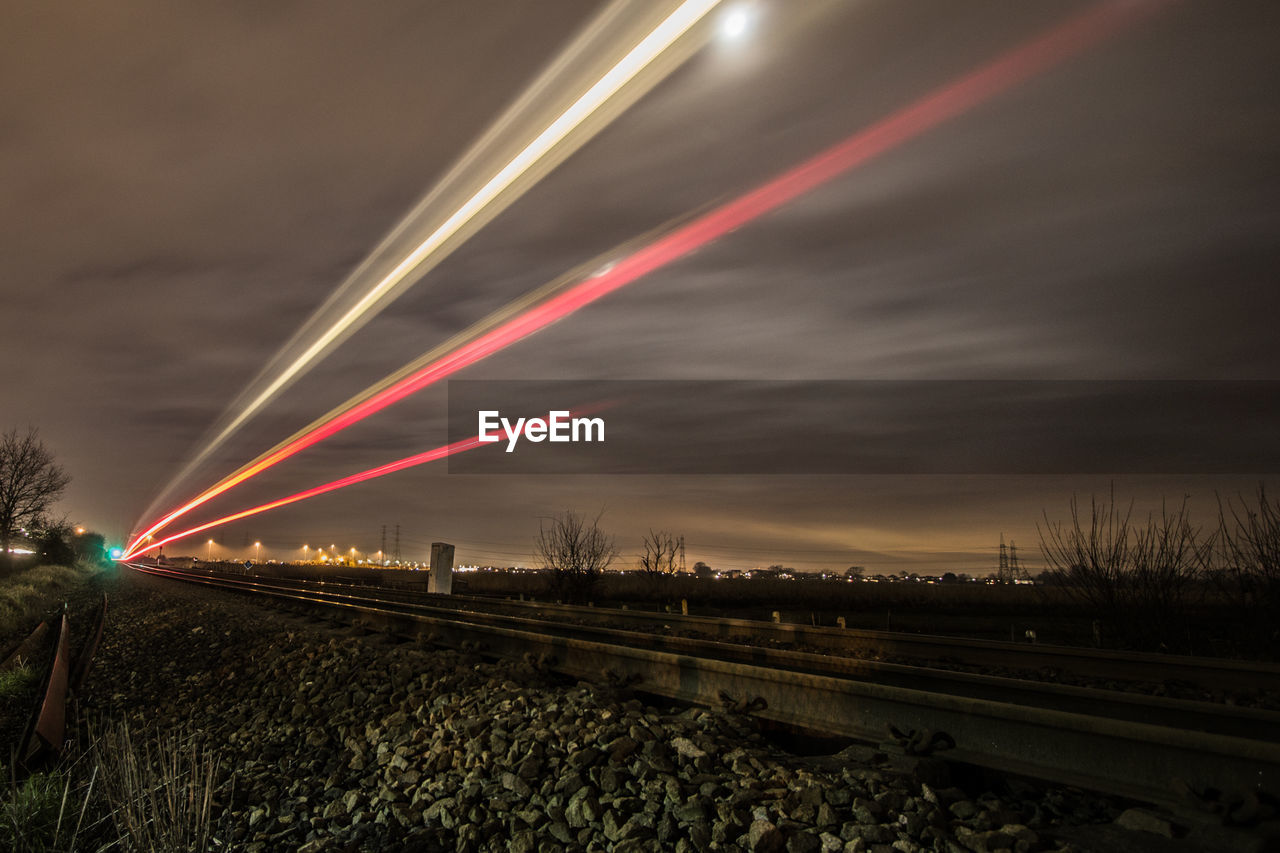 Low angle view of light trails at night