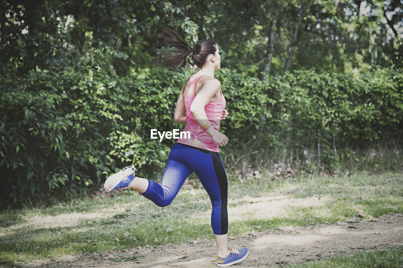 Full length of young woman running at park