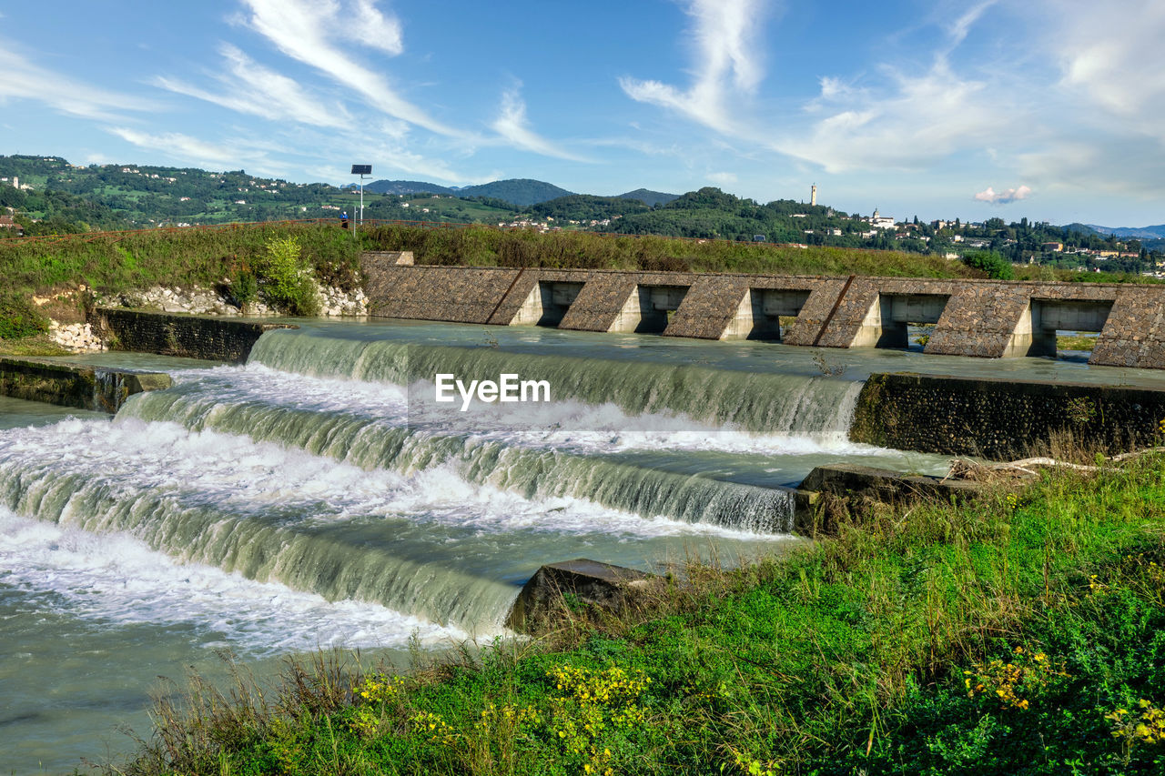 waterfall, water, dam, environmental conservation, motion, nature, hydroelectric power, architecture, reservoir, environment, renewable energy, sky, river, built structure, flowing water, power generation, scenics - nature, plant, long exposure, cloud, flowing, beauty in nature, travel destinations, water feature, no people, body of water, landscape, outdoors, travel, alternative energy, tourism, splashing, irrigation equipment, water sports, day, land, reflection, power in nature, sports