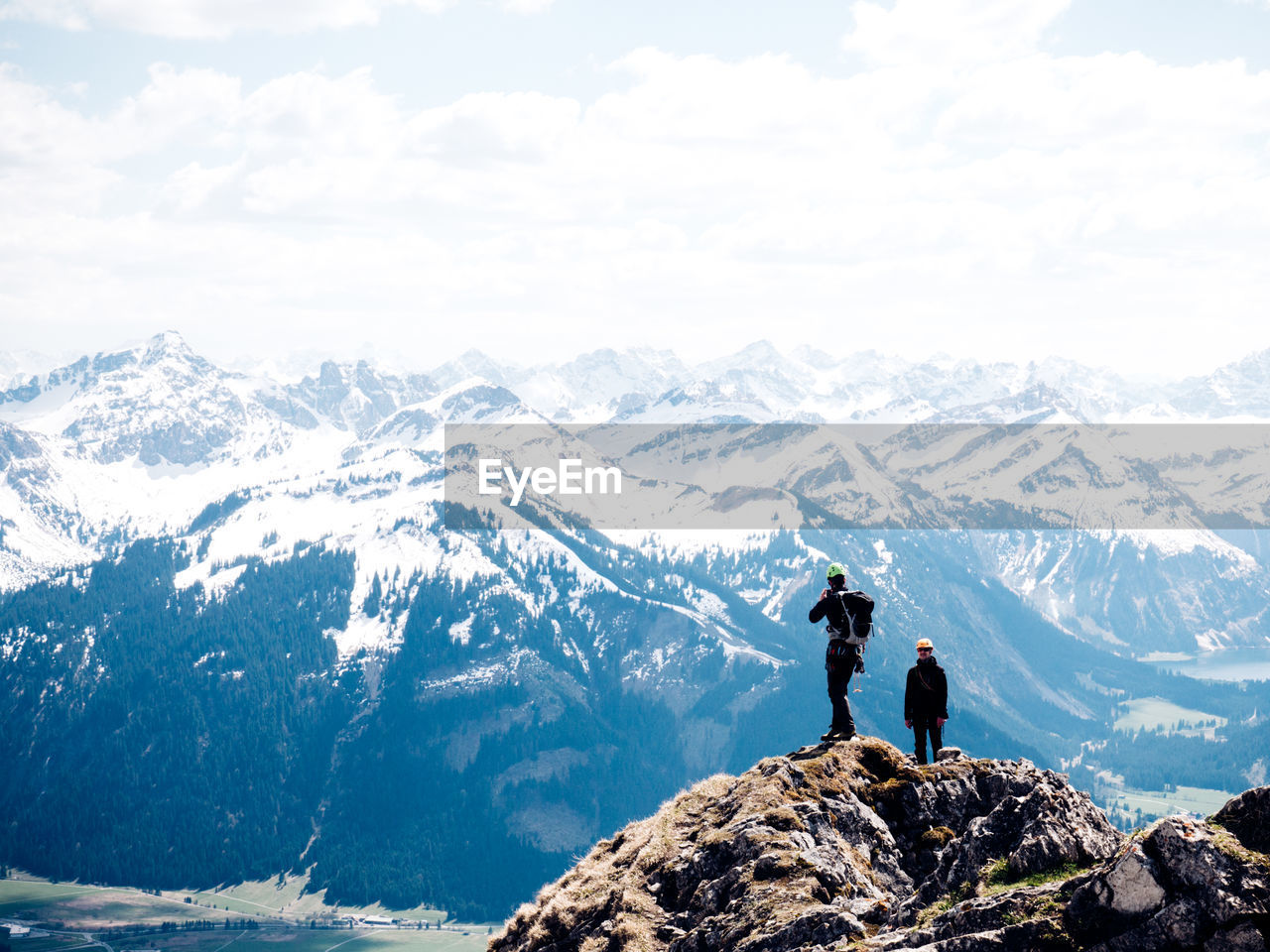 PEOPLE IN MOUNTAINS AGAINST SKY