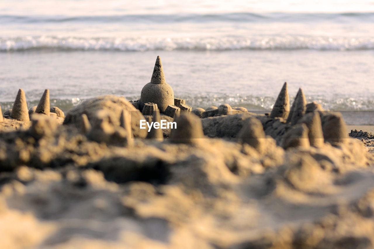 Sandcastle with the sea in the background.