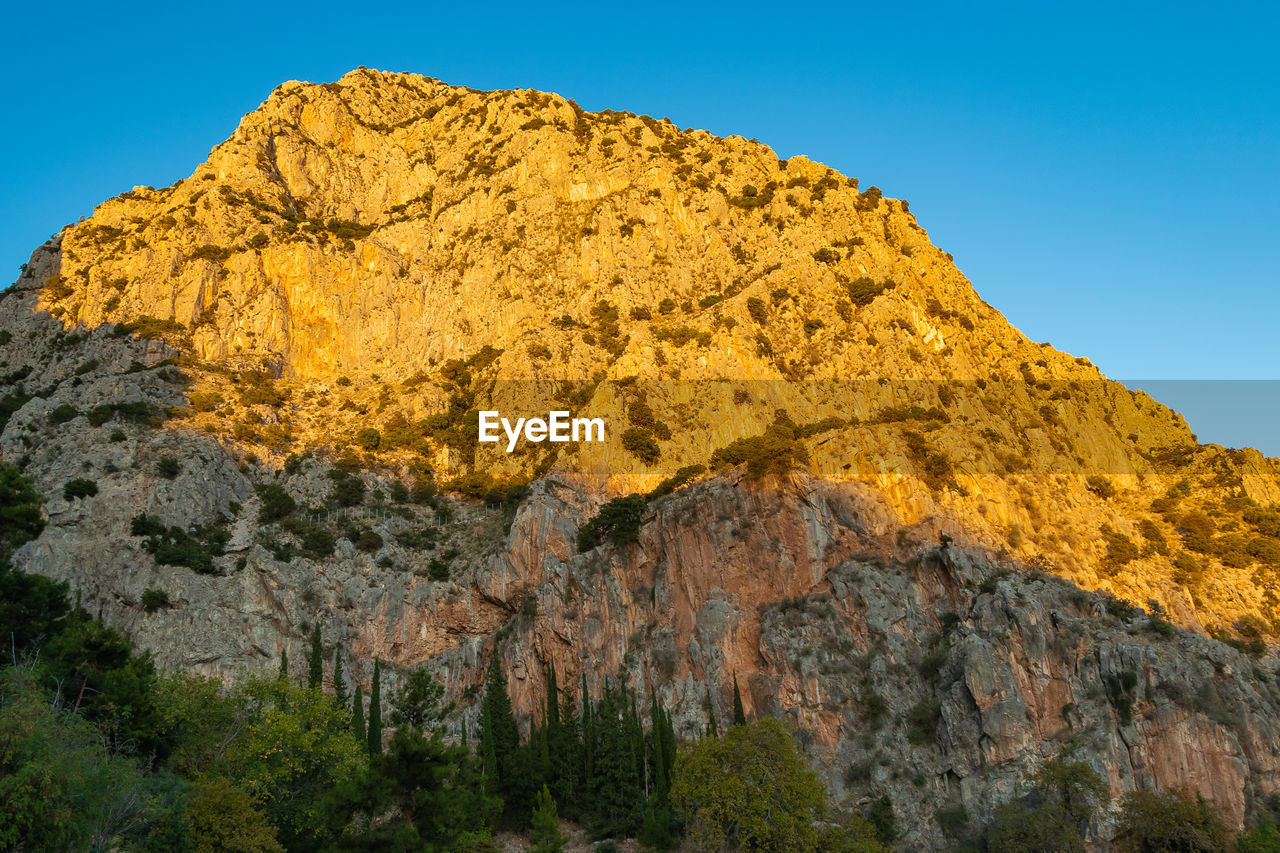 Low angle view of rock formation against sky