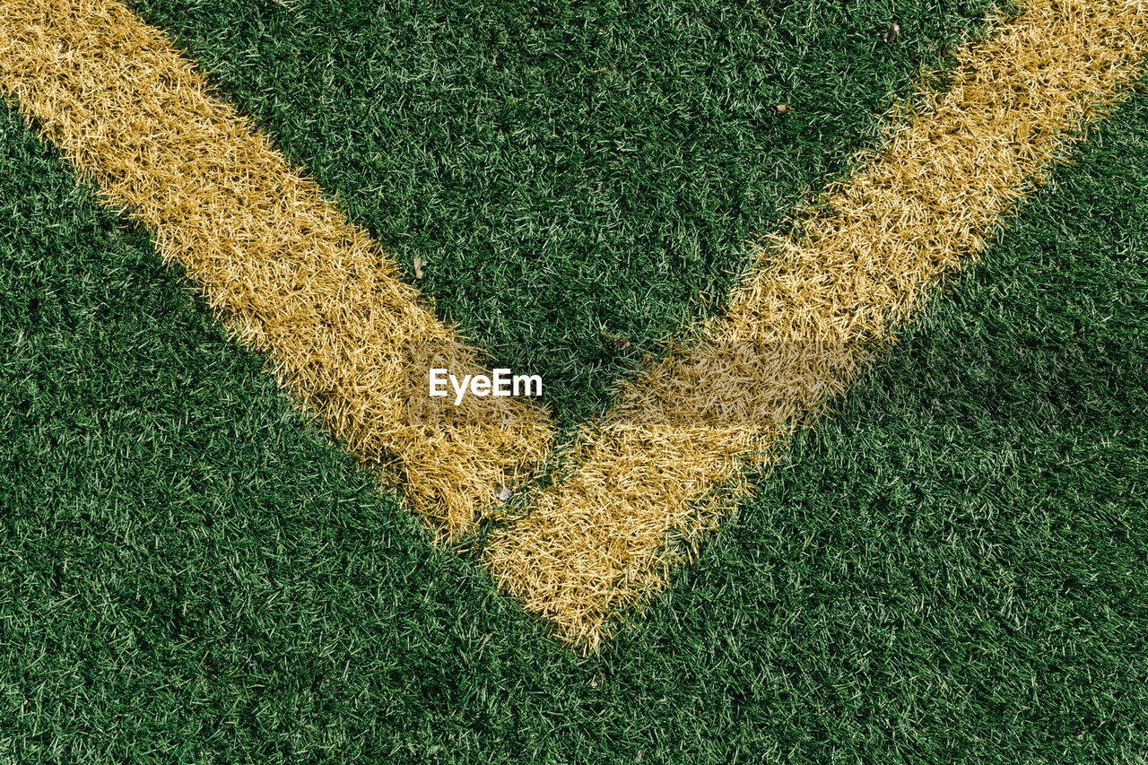 High angle view of yellow yard line on soccer field